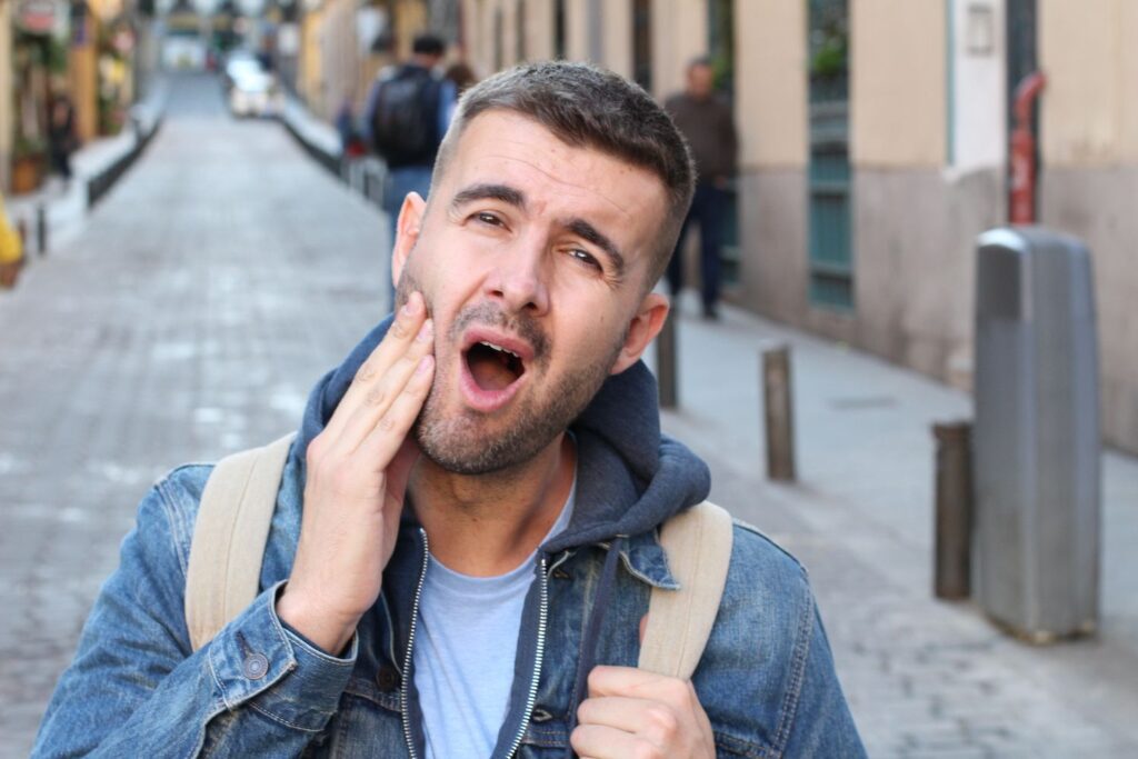 Man holding his jaw in pain because of TMJ dentist in Alpharetta Georgia